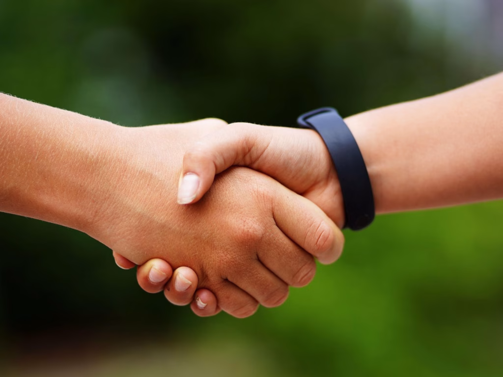 Two person handshaking while becoming a membor